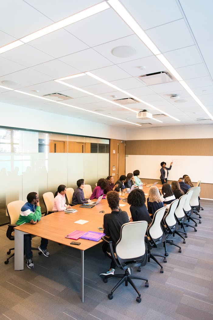 about-us Professional team engaged in a collaborative boardroom meeting with a presentation in progress.