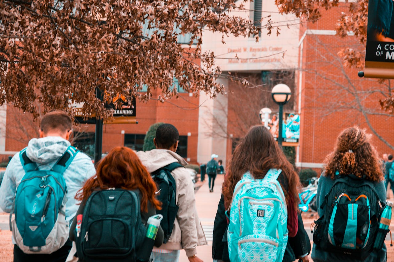 services-02 A group of college students with backpacks walking together outdoors on campus.